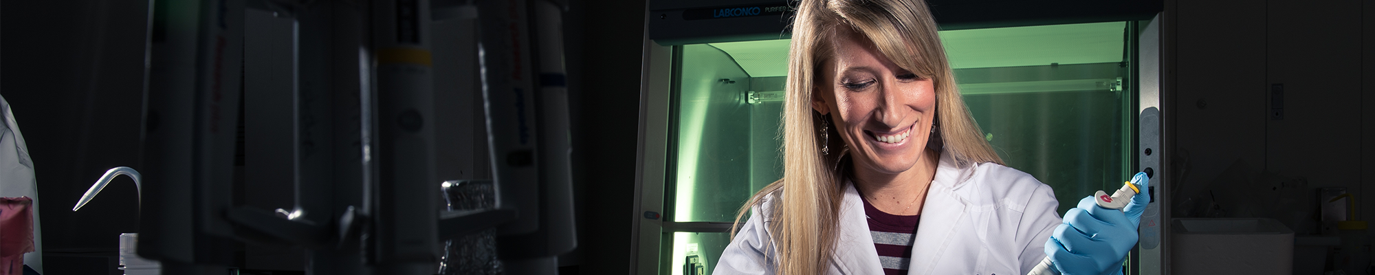 A student using a beaker and pipette